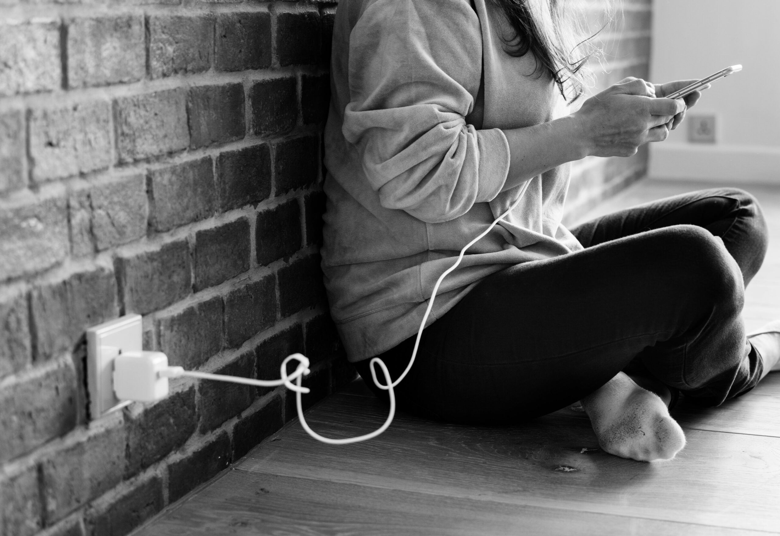 young-woman-using-smartphone-as-it-is-being-charged-2
